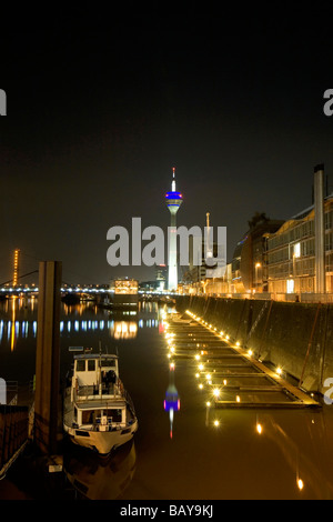 Modern architecture of the Media Harbour at night with television tower, Neuer Zollhof, Duesseldorf, state capital of NRW, North Stock Photo