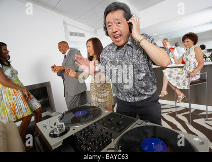 Asian DJ performing at party Stock Photo