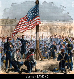 Major Robert Anderson raising the American flag over Fort Sumter before the Confederate attack December 27 1860. Hand-colored woodcut Stock Photo