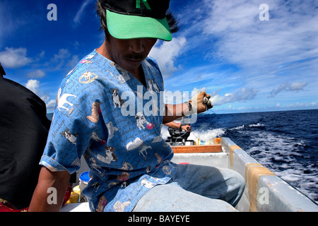 A man trolls for tuna near Pohnpei Island, Federated States of Micronesia. Stock Photo