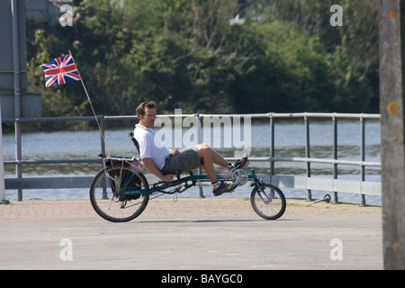 disabled male cyclist low riider flag cycle river medway allington lock maidstone kent england uk europe Stock Photo