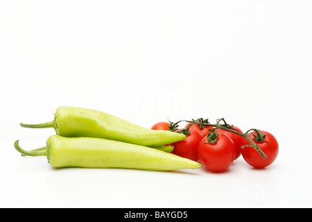 Tomatoes and green paprikas isolated (cutout) on white background. Close up. May, 2009 Stock Photo