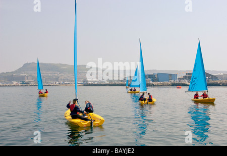 Young people sail training with a Laser Pico sailing dinghy at Weymouth and Portland Sailing Academy Dorset England Stock Photo