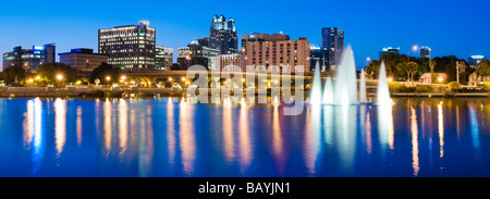 Downtown skyline of Orlando Florida reflects in Lake Lucerne at sunset Stock Photo