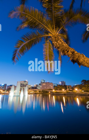 Downtown skyline of Orlando Florida reflects in Lake Lucerne at sunset Stock Photo