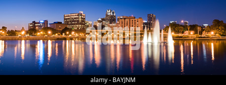 Downtown skyline of Orlando Florida reflects in Lake Lucerne at sunset Stock Photo