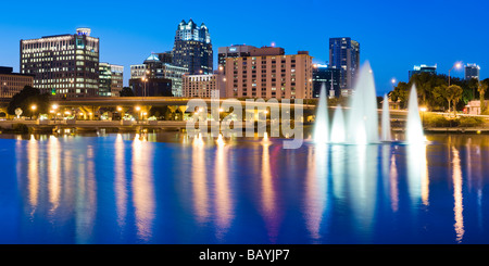 Downtown skyline of Orlando Florida reflects in Lake Lucerne at sunset Stock Photo