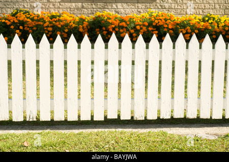 white picket fence with flower bed Stock Photo