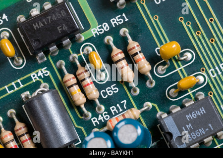 Resistors, capacitors and integrated silicon micro chips on an electronic circuit board motherboard Stock Photo