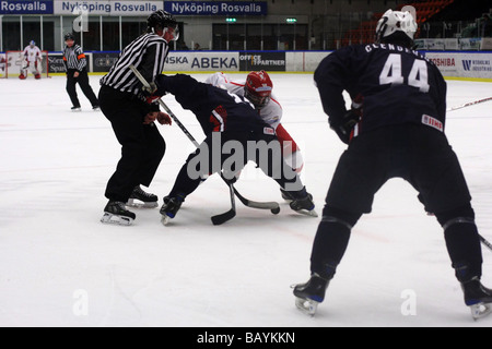 Face-off in a U18 ice-hockey game between USA and Russia. Stock Photo