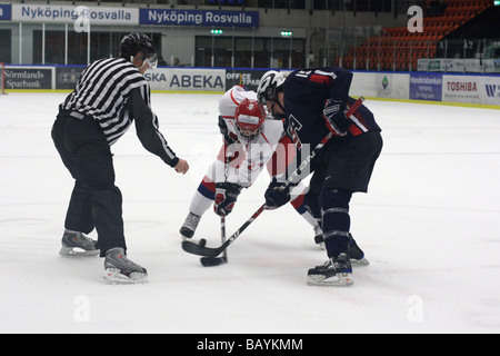 Face-off in a U18 ice-hockey game between USA and Russia. US no 15 is Drew Shore. Stock Photo