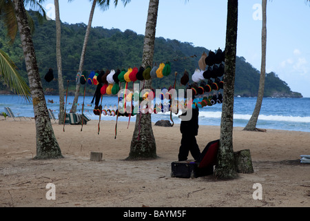 Man selling hats on island beach Stock Photo