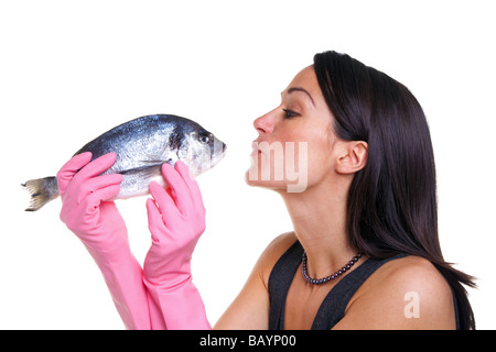 Woman in pink rubber gloves about to kiss a fish isolated on white background Stock Photo