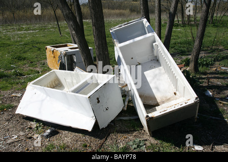 old fridge freezers dumped in field in countryside Stock Photo