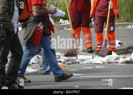 two female road cleaners in litter covered street in italy Stock Photo