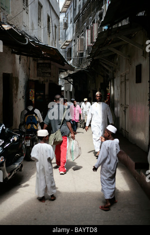 Crowd of people in a narrow lane in Stone Town Zanzibar Stock Photo