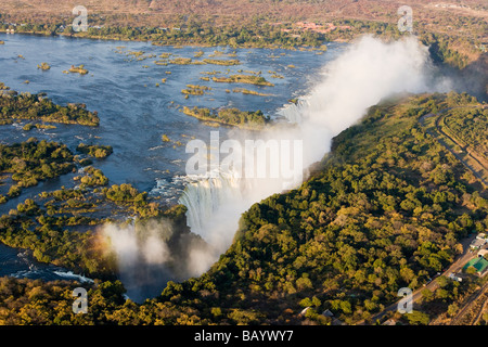 Aerial helicopter full view of misty Victoria Falls bordering Zambia and Zimbabwe one of 7 Natural Wonders and biggest waterfall in the world Stock Photo