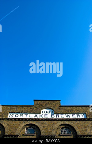 the name mortlake brewery and the date 1869 on a brick building in mortlake, southwest london, england Stock Photo