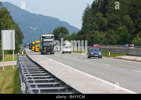 Autobahn in Austria near Salzburg. A1 autobahn in Austria on a busy summer afternoon. Numerous lorries and cars are seen passing by. Stock Photo