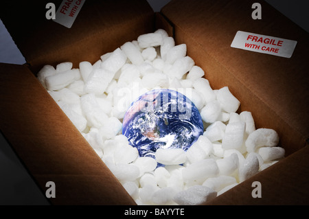 Planet Earth in Open Cardboard Box Surrounded by Protective Packing and Marked as Fragile Stock Photo