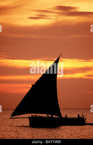 Dhow sailing off the shore of Stonetown in Zanzibar Stock Photo