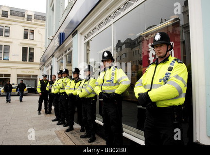Police protect the RBS bank office in Brighton during the Mayday Protests Stock Photo