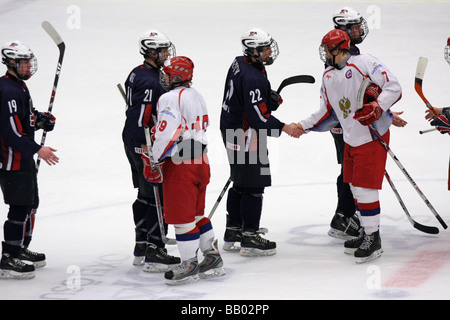 Players shaking hands after the match in a U18 ice-hockey game between USA and Russia. Stock Photo