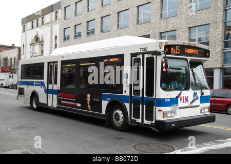 A Bx15 New York City bus waiting at traffic lights on 125th Street (Dr Martin Luther Boulevard), New York. Stock Photo