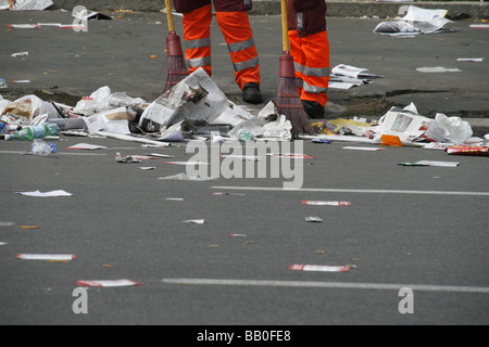 two female road cleaners in litter covered street in italy Stock Photo