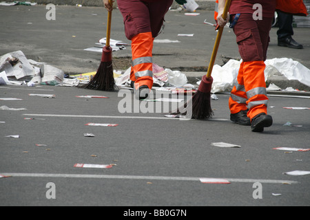 two female road cleaners in litter covered street in italy Stock Photo