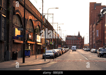 Railway arches, Whitworth Street West, near Oxford Road Station, with the City Road Inn pub at the end, Manchester, UK Stock Photo