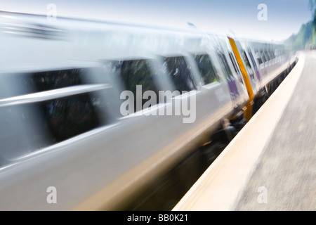 Train moving fast through the station. Stock Photo