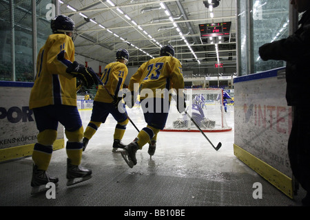 Swedish team entering the ice in a U18 ice-hockey tournament. Stock Photo