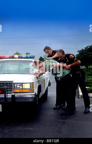 Police officers arrest a young man  drunk driving with patrol car Stock Photo