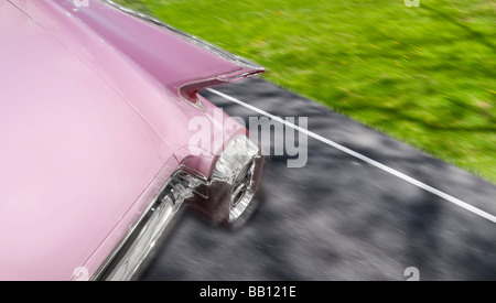 Pink Cadillac 1959 Fleetwood Car Detail of Rear Fins While Driving On Road With Motion Blur, Michigan USA Stock Photo