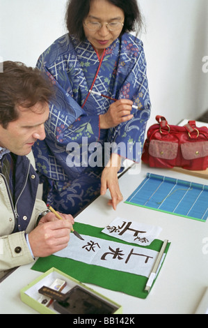 Japanese shodo teacher with a student Stock Photo