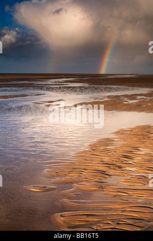 Rainbow at Budle bay near Bamburgh. Stock Photo