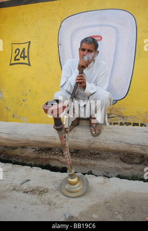 Man smoking shisha on the street of New Delhi Stock Photo