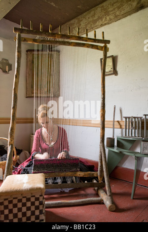 Woman weaving with Iroquois style loom at Nellis Tavern historic site textile fair New York state Mohawk Valley Stock Photo