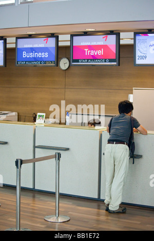 Young Korean Man at the Asiana Airlines Counter in ICN Seoul Incheon Airport Stock Photo