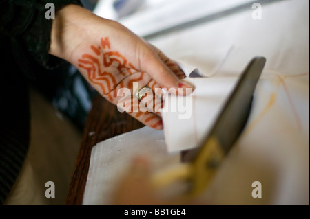 Close up of womans hands who is working for organization that hires only widows to make clothing, Kabul, Afghanistan. Stock Photo