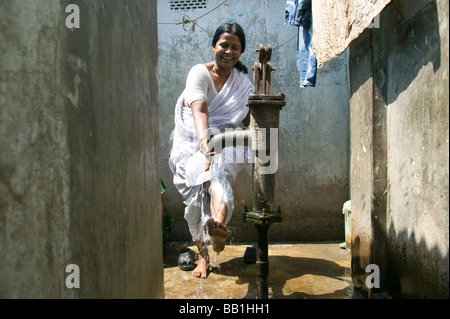 Leader for women's rights washing her feet in brothel, Tangail, Bangladesh. Stock Photo