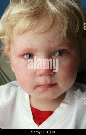 Close up of a child who has just finished crying and still has tears in ...