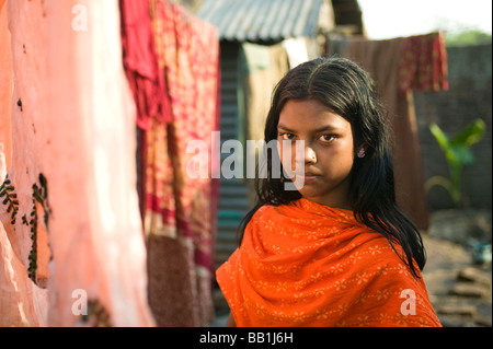 Girl hanging clothes to dry, Mipur Village, outside of Dhaka, Bangladesh. Stock Photo
