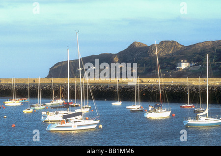 Yachts moored at Howth Harbour overlooked by Howth Head in County Dublin Ireland Stock Photo
