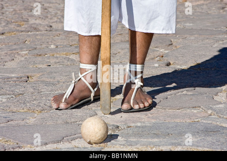 Native man wearing hurache sandal made of leather thongs with car tires for soles demonstrates ball race in Copper Canyon Mexico Stock Photo