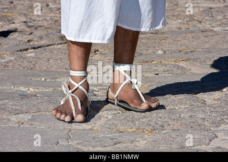 Native man wearing hurache sandal made of leather thongs with car tires for soles demonstrates ball race in Copper Canyon Mexico Stock Photo