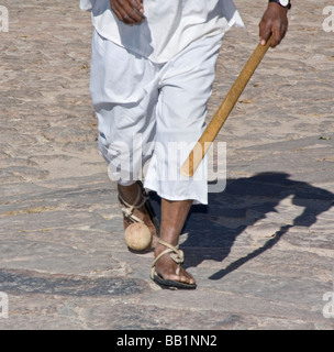 Native man wearing hurache sandal made of leather thongs with car tires for soles demonstrates ball race in Copper Canyon Mexico Stock Photo