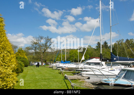 Boats moored at the Swan Hotel Marina, next to the Swan Hotel, Newby Bridge, Lake District National Park, Cumbria, England UK Stock Photo