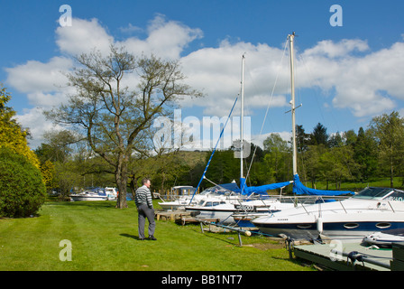 Boats moored at the Swan Hotel Marina, next to the Swan Hotel, Newby Bridge, Lake District National Park, Cumbria, England UK Stock Photo